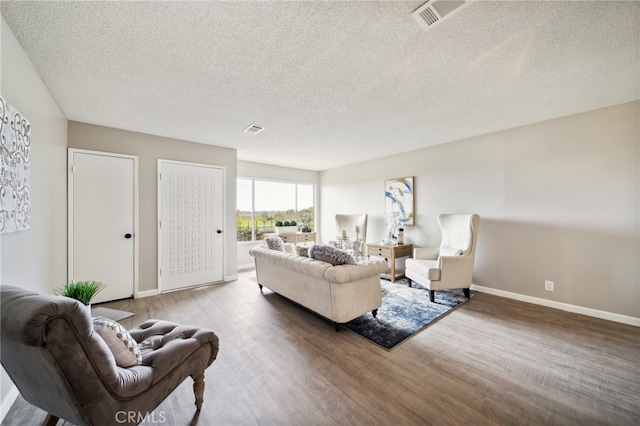 living room featuring a textured ceiling and hardwood / wood-style floors