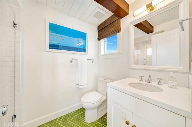 bathroom with toilet, vanity, and a shower with door