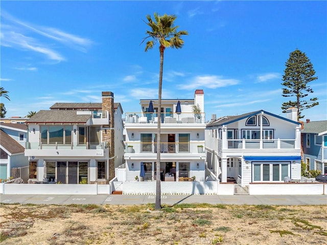 back of house featuring a balcony