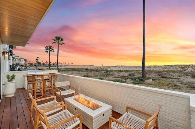 balcony at dusk with a fire pit