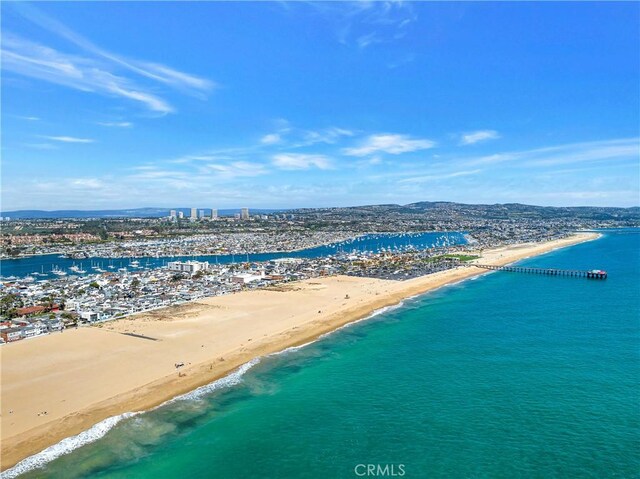 drone / aerial view with a water view and a beach view