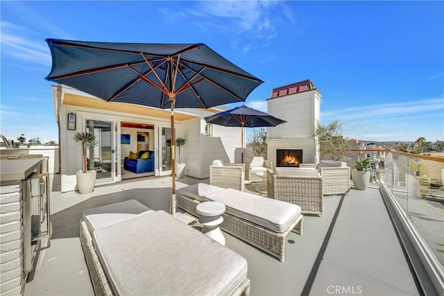 view of patio / terrace featuring an outdoor fireplace