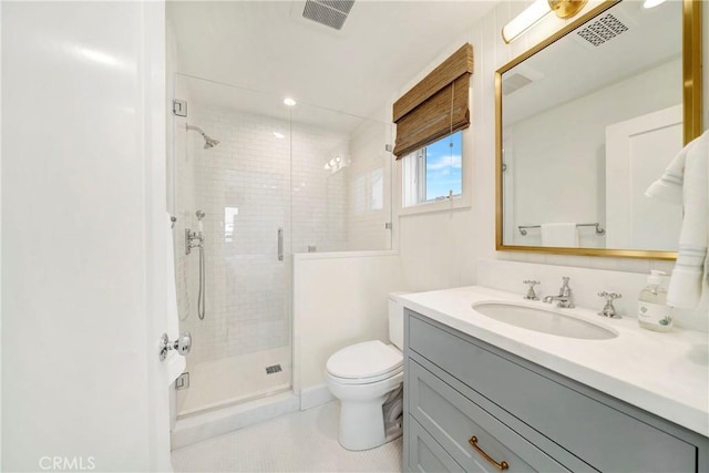 bathroom featuring a shower with shower door, toilet, and vanity