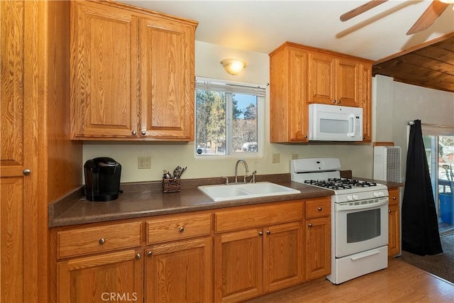 kitchen with ceiling fan, sink, light hardwood / wood-style flooring, and white appliances