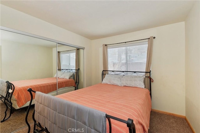 bedroom with a closet, carpet floors, and multiple windows