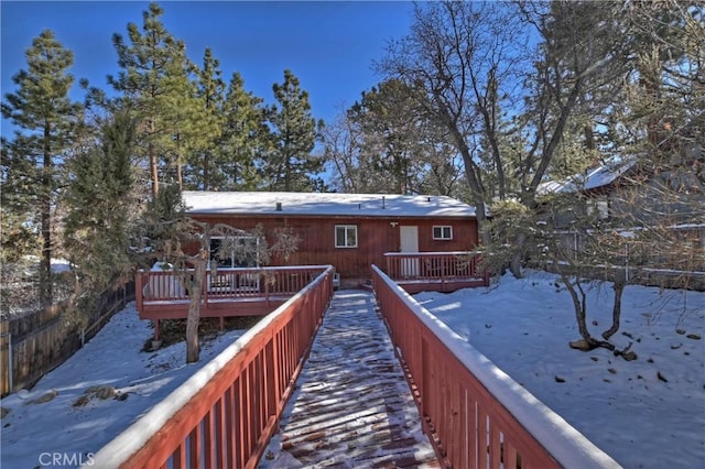 snow covered property featuring a deck