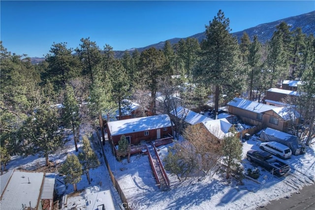 snowy aerial view with a mountain view