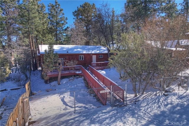 snow covered property featuring a wooden deck