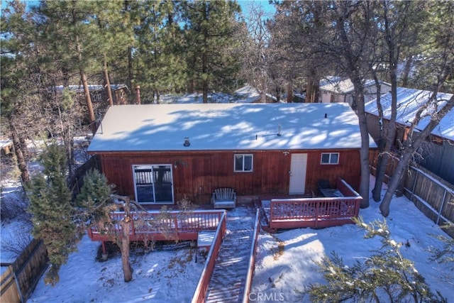 snow covered house with a deck