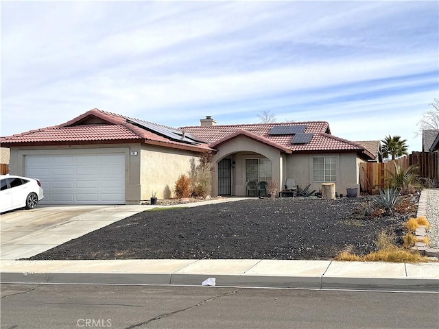 view of front of property with a garage and solar panels