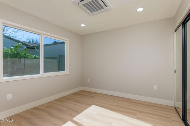 unfurnished room with light wood-type flooring