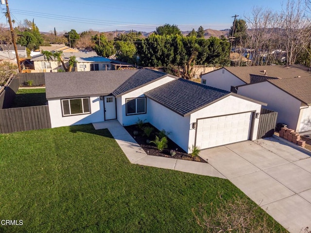 single story home featuring a garage and a front lawn