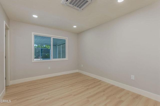 spare room featuring light hardwood / wood-style flooring