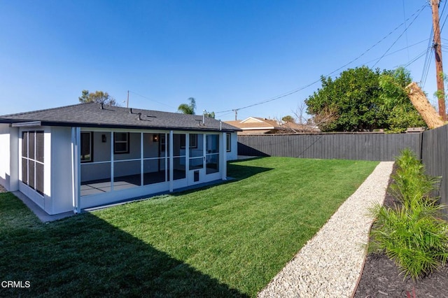 back of house with a lawn and a sunroom