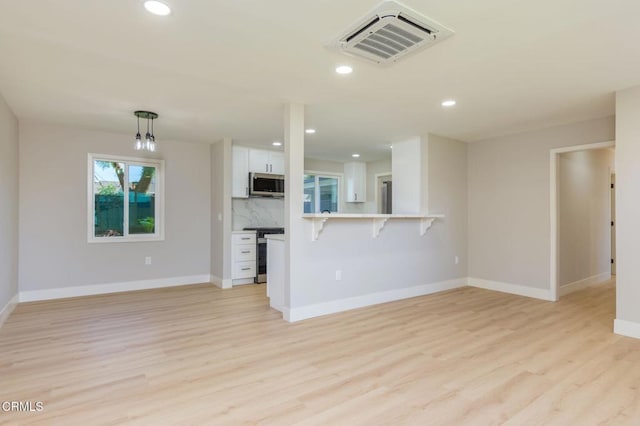 unfurnished living room featuring light hardwood / wood-style floors