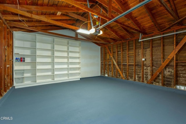 garage with wooden ceiling and a garage door opener