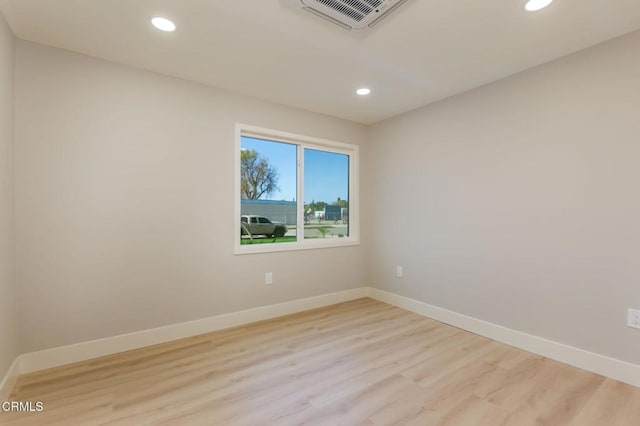 spare room featuring light hardwood / wood-style floors