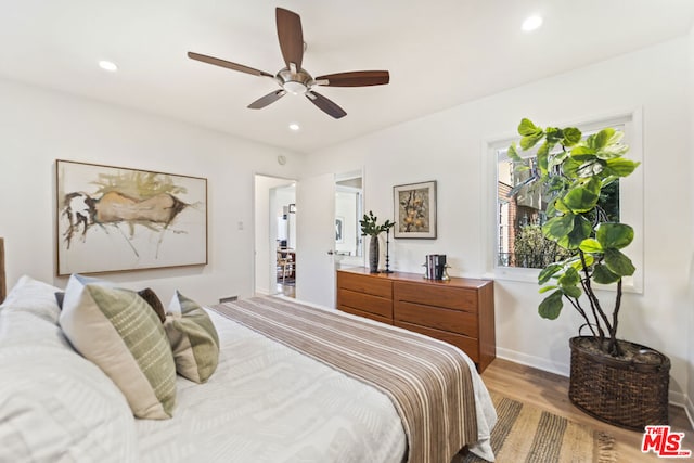 bedroom featuring ceiling fan and light hardwood / wood-style floors