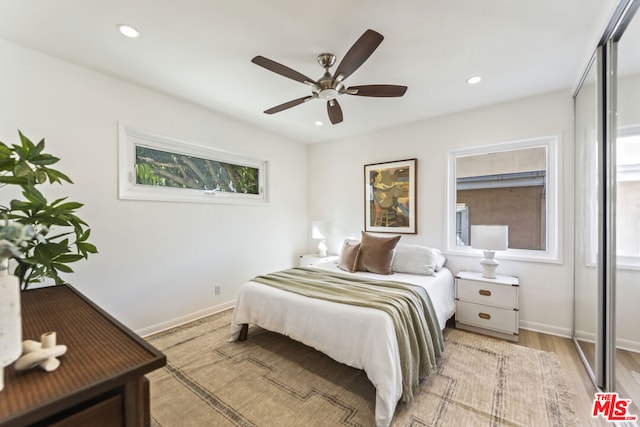 bedroom with ceiling fan and light wood-type flooring