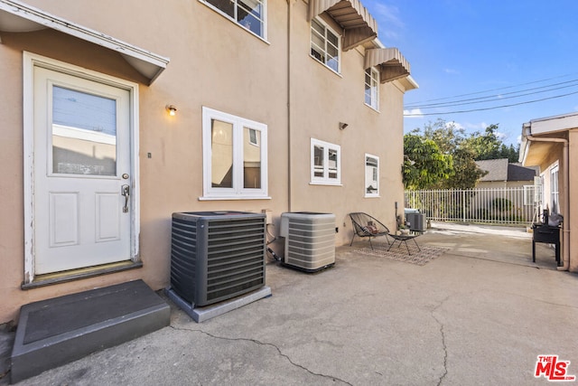 doorway to property featuring a patio area and central AC