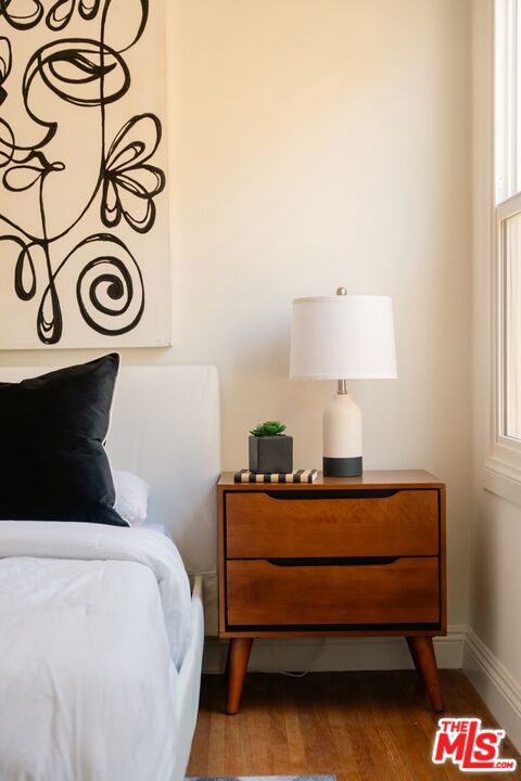 bedroom featuring hardwood / wood-style floors and multiple windows