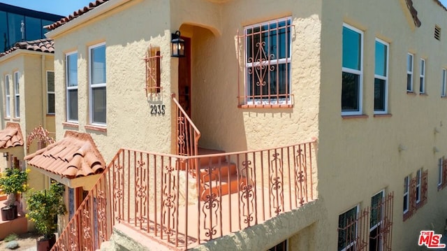 view of side of home featuring a balcony