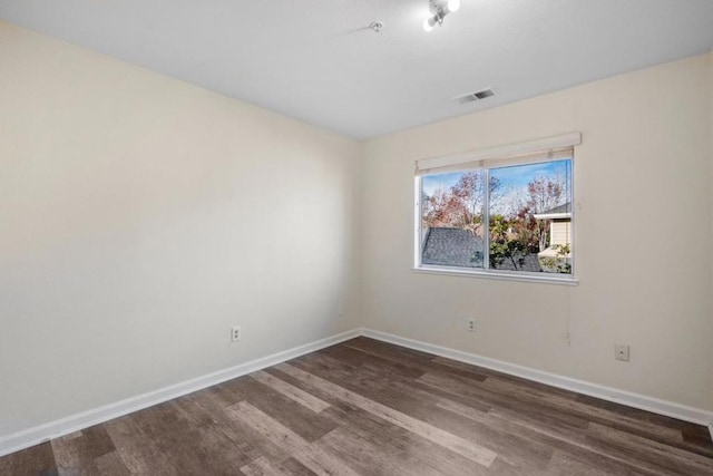 unfurnished room featuring dark hardwood / wood-style flooring