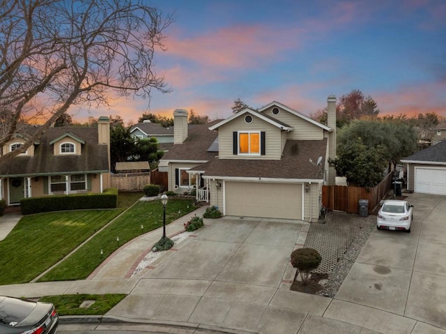 view of front facade with a lawn and a garage