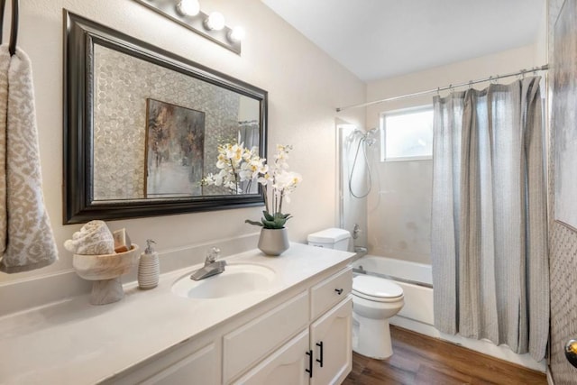 full bathroom with toilet, hardwood / wood-style flooring, shower / bath combo, and vanity