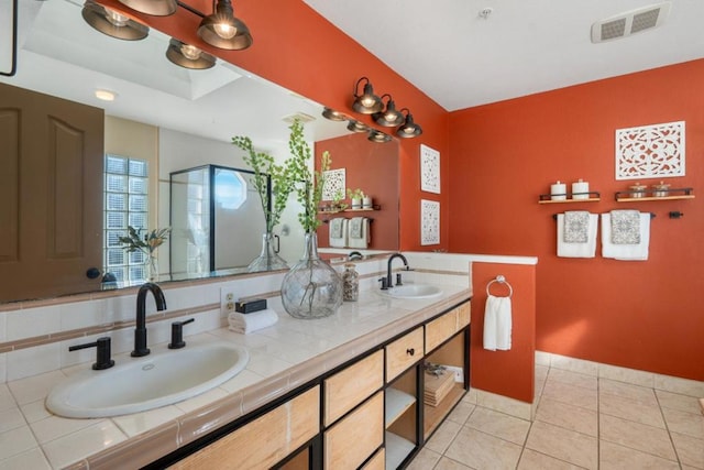 bathroom featuring tile patterned floors, tasteful backsplash, and vanity