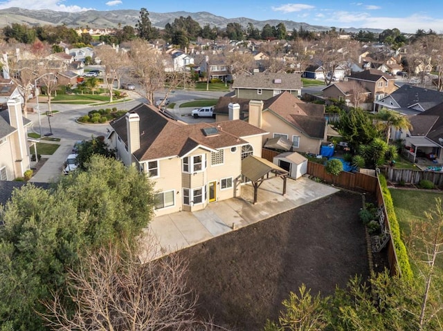 birds eye view of property with a mountain view