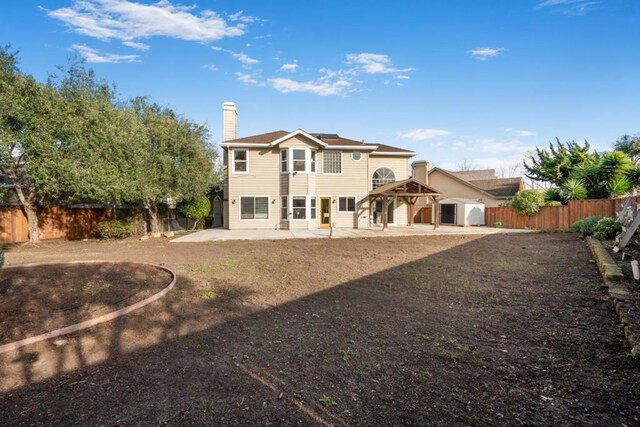 rear view of house with a gazebo and a patio