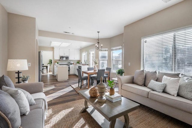 living room with a notable chandelier and hardwood / wood-style floors