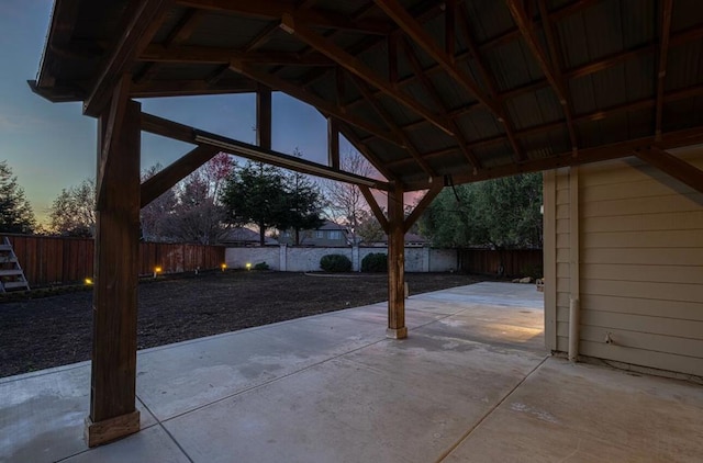 patio terrace at dusk featuring a gazebo