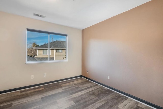 empty room with dark hardwood / wood-style floors