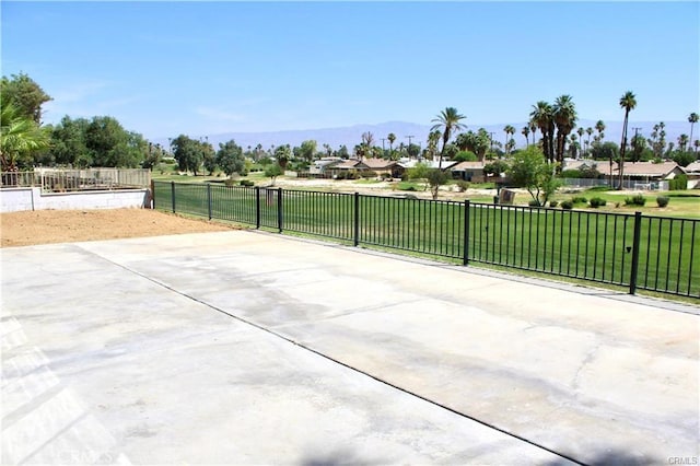 view of patio featuring fence and a mountain view