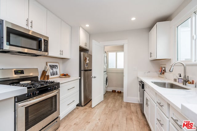 kitchen with sink, white cabinets, and appliances with stainless steel finishes