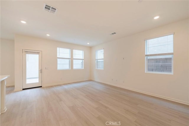 unfurnished room featuring light hardwood / wood-style floors