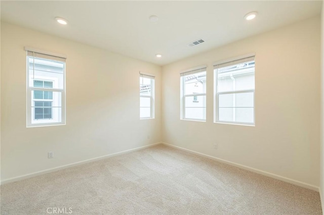 unfurnished room with light carpet