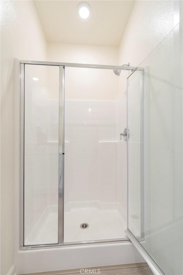 bathroom with a shower with door