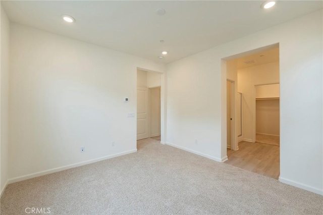 spare room featuring light colored carpet