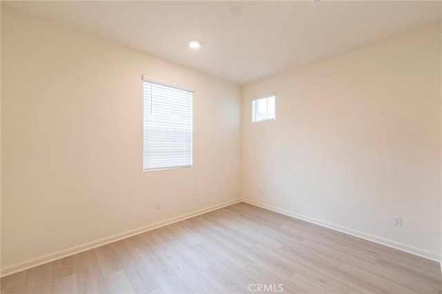 spare room featuring light hardwood / wood-style floors