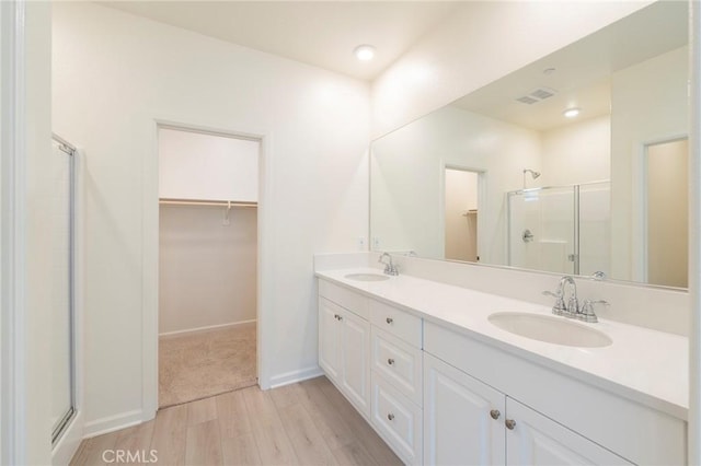 bathroom featuring vanity, hardwood / wood-style floors, and an enclosed shower