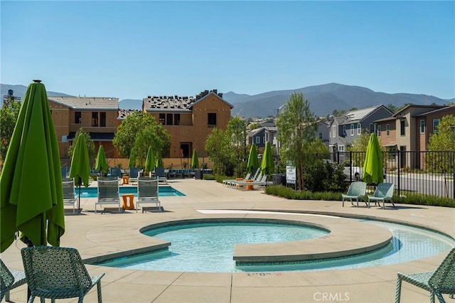 view of swimming pool featuring a mountain view and a patio