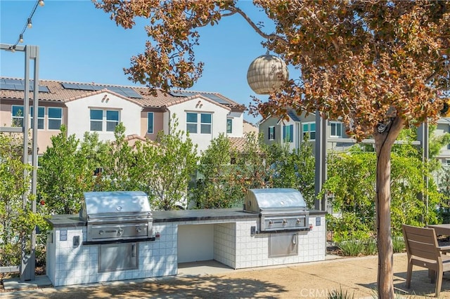 view of patio / terrace featuring an outdoor kitchen and a grill