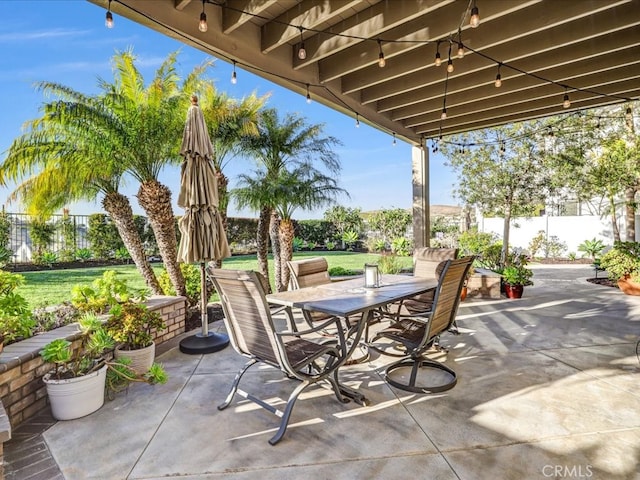 view of patio with fence and outdoor dining space