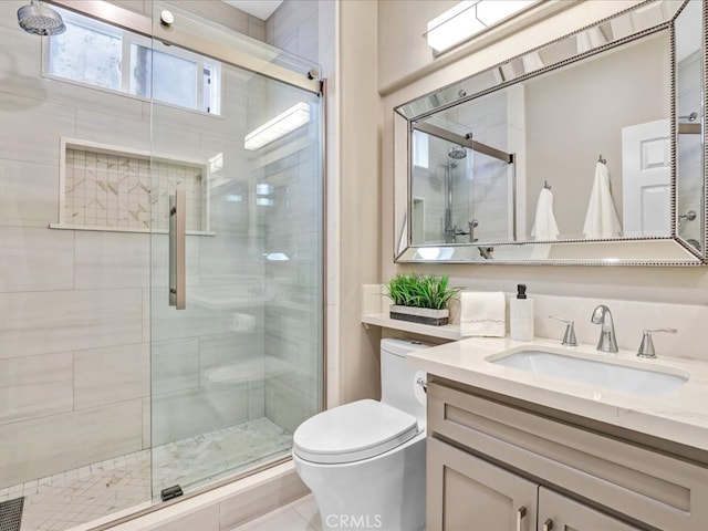 bathroom with toilet, a stall shower, and vanity