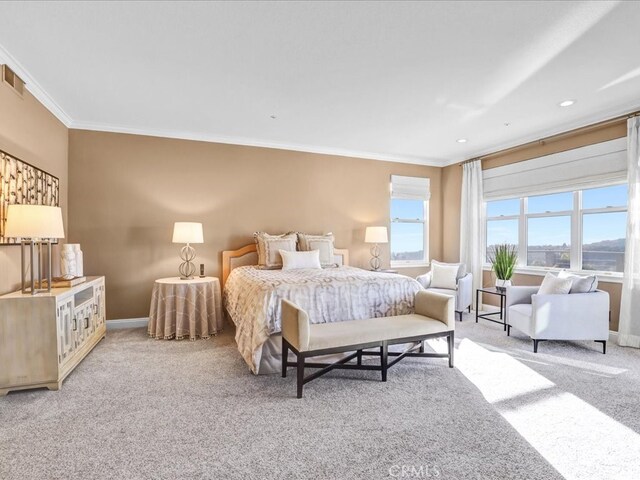 carpeted bedroom featuring ornamental molding, recessed lighting, visible vents, and baseboards