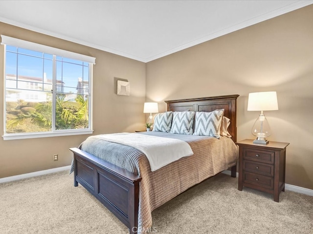 bedroom with baseboards, crown molding, and light colored carpet