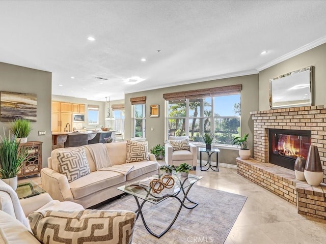 living room with a textured ceiling, a fireplace, crown molding, and recessed lighting